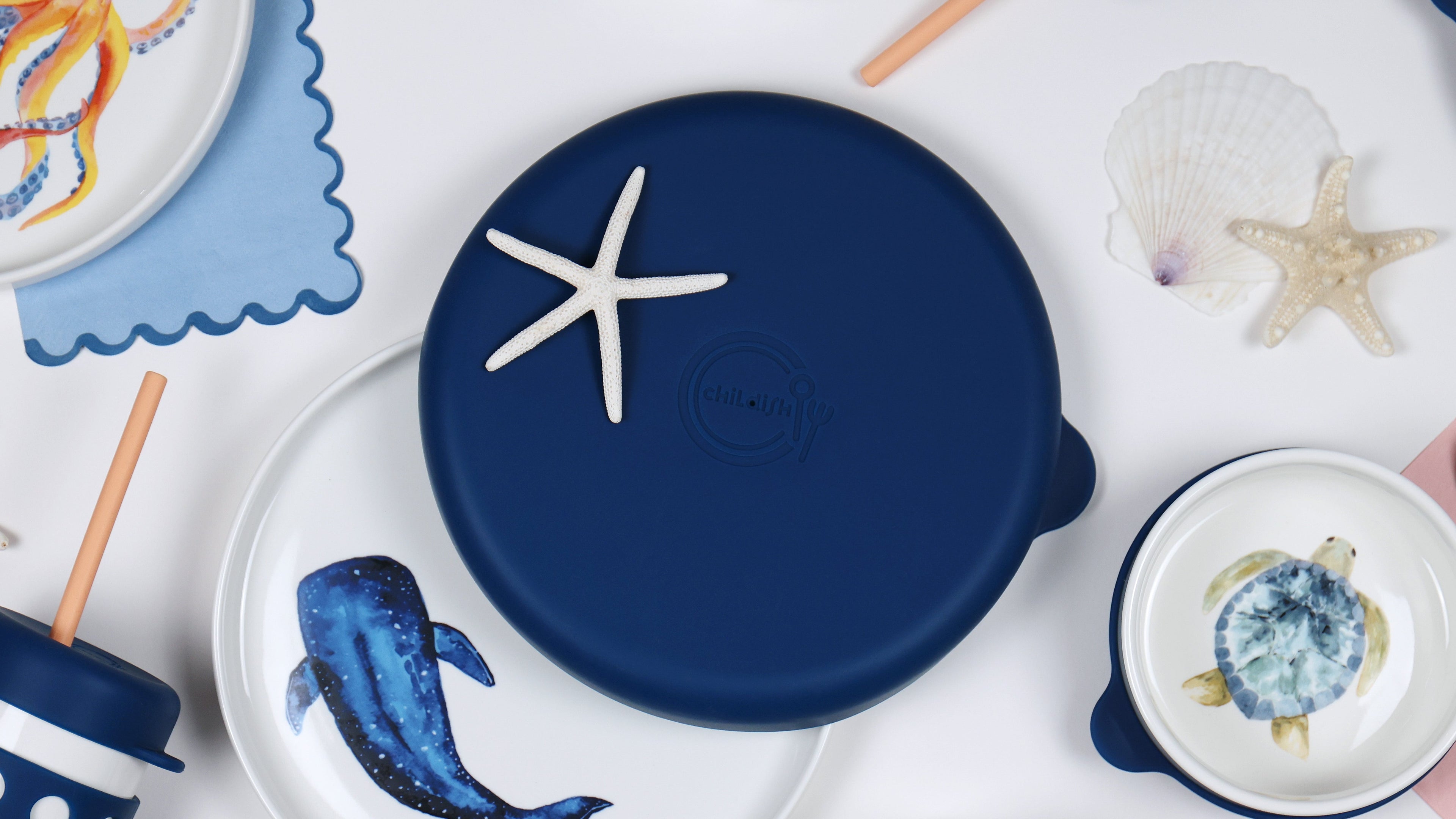 Set of ceramic plates with animal designs on a white surface