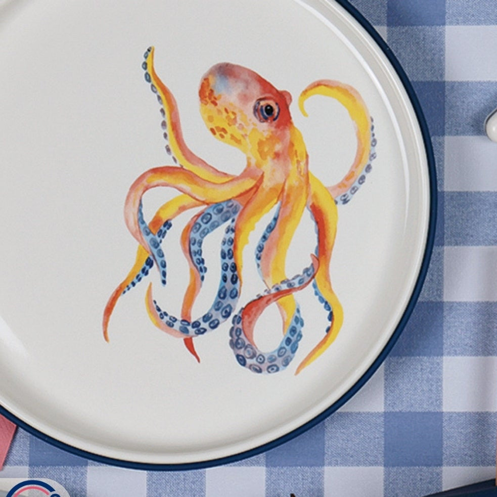 Children's plates with a colorful octopus design on a checkered tablecloth.