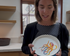 Woman holding a plate with an octopus design in a kitchen setting